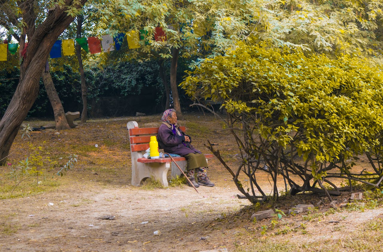 elderly-woman-relaxing-in-peaceful-park-setting-28861003